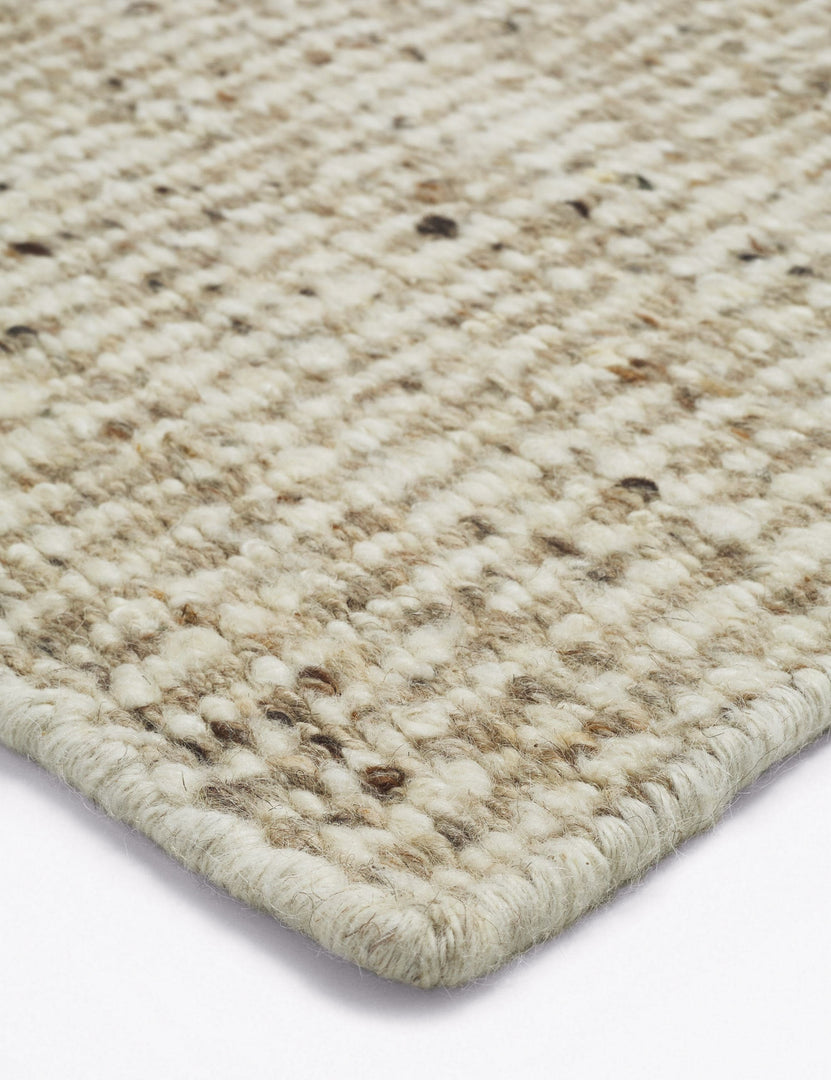 #color::neutral #size::10--x-14- #size::2-6--x-8- #size::6--x-9- #size::8--x-10- #size::9--x-12- | Corner of the Taos neutral light brown wool blend area rug.