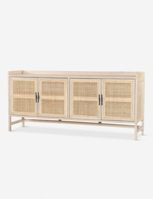 Angled view of the Philene natural mango wood sideboard with cane doors