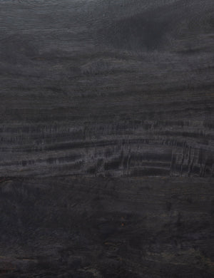 Detailed view of the black mango wood on the Philene sideboard with cane doors