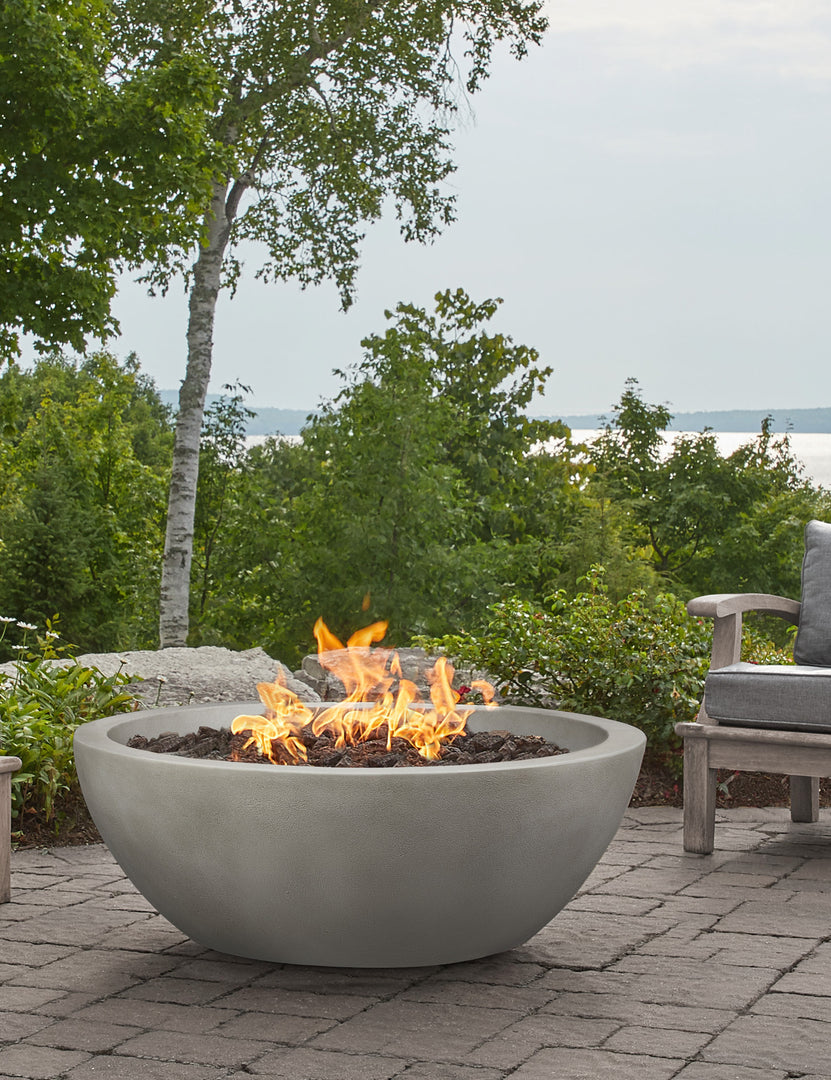 #color::shade #size::42- #configuration::natural-gas | The Benno shade fire bowl sits in an outdoor space next to outdoor lounge furniture