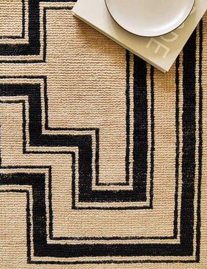 Close-up of the Senna neutral hand-knotted wool area rug with black geometric pattern