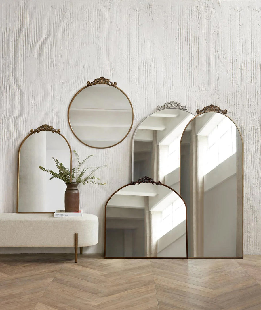 | The tulca narrow floor mirror sits against a wall in a studio room with other mirrors from the tulca collection