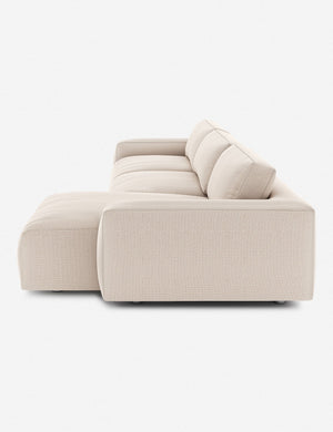 Side of the Mackenzie ivory linen right-facing sectional sofa