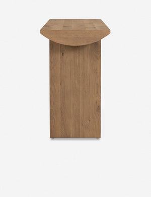 Side view of the Remwald sculptural oak wood console table.