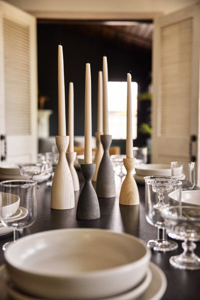 #size::small #size::medium #color::natural #color::grey #color::white | The Pantry wooden candlesticks with smooth curves by farmhouse pottery in gray, neutral, and white sit on a black dining room table