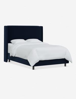 Angled view of Adara navy velvet upholstered bed.