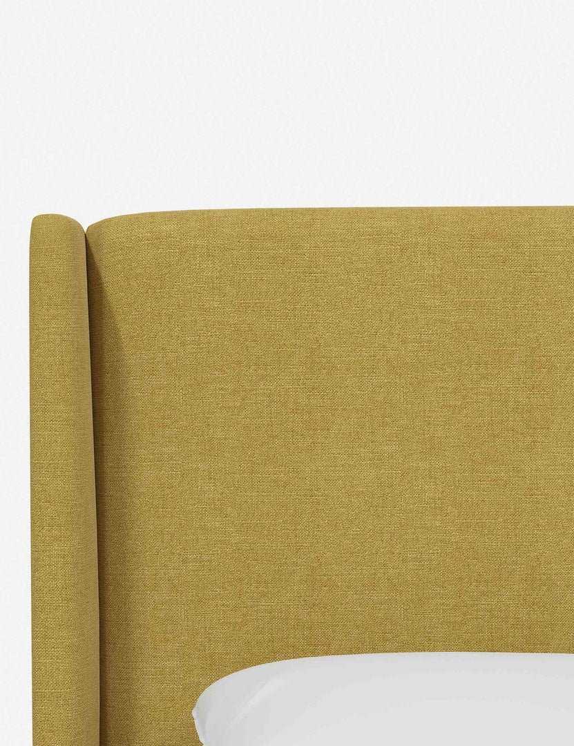 #color::golden-linen #size::twin #size::full #size::queen #size::king #size::cal-king | Close-up of the subtle winged headboard and trim lines on the Adara yellow linen upholstered bed.