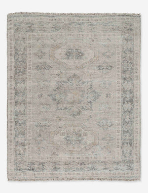 Ismenia distressed sand-toned persian rug with fringed ends