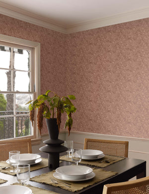 The Alaari wallpaper is in a dining room with a black dining table, rattan dining chairs, and white serveware