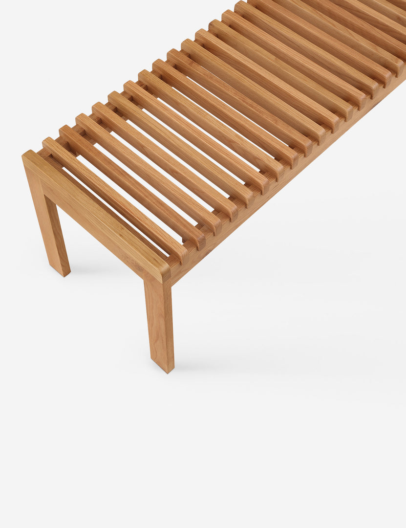 #color::natural-oak | Close up of the Olson mid-century slatted wood bench in natural oak.