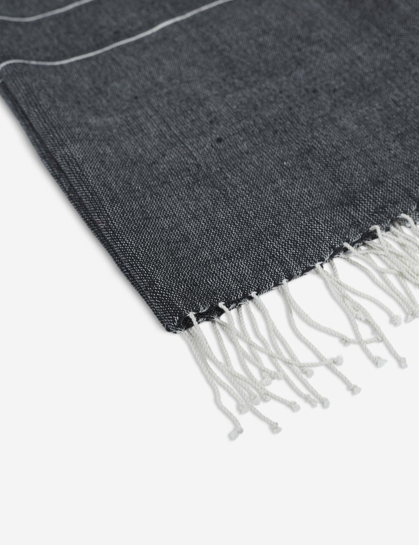 #color::onyx | Close-up of the fringed ends on the Melkam onyx gray Hand Towel by Bolé Road Textiles