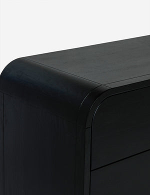 Rounded corner of the brooke black oak 6-drawer rounded dresser