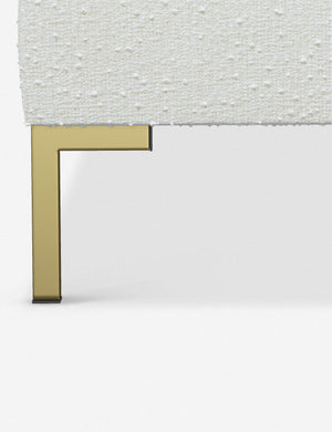 The golden leg on the Deva White Boucle platform bed