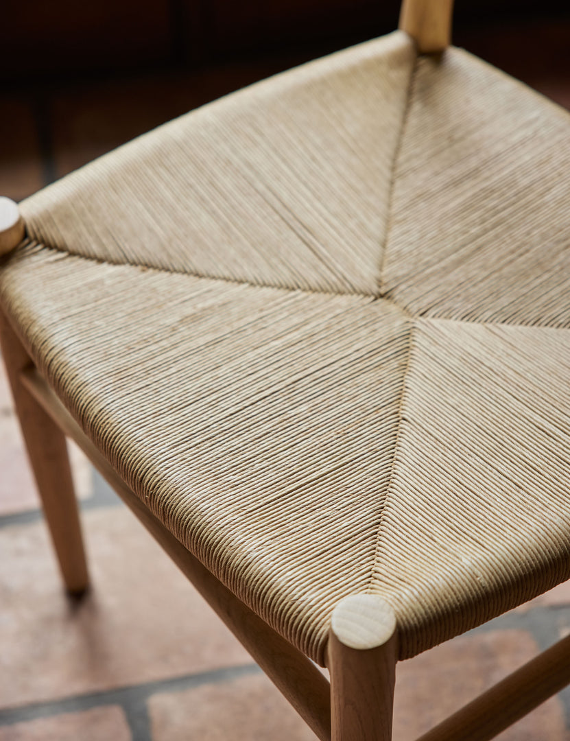 #color::natural-oak | Close up view of the woven seat of the Nicholson slim natural oak wood frame and woven seat dining chair.