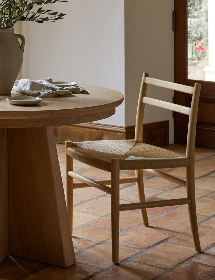 #color::natural-oak | Nicholson slim natural oak wood frame and woven seat dining chair styled with a round dining table.