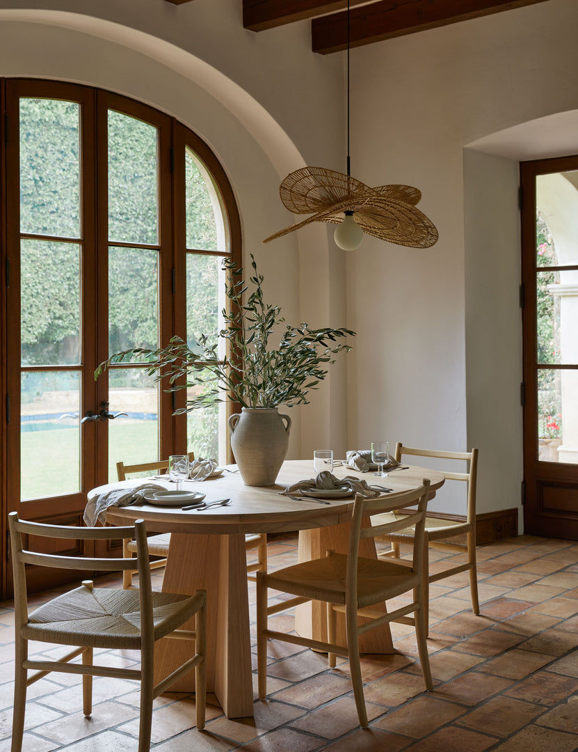 #color::natural-oak | Four Nicholson slim natural oak wood frame and woven seat dining chair styled around an oval light wood dining table.