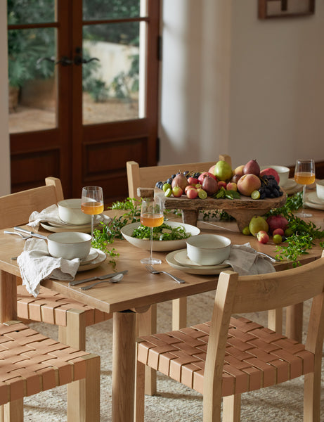 #color::sand | The set of six sand-toned stoneware nature dinner plates by thomas for rosenthal sit atop a wooden dining table in a dining room with woven chairs and an elevated wooden center piece 