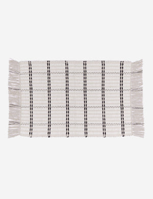 Elin cotton mat featuring a thick fringe and black and white stripes