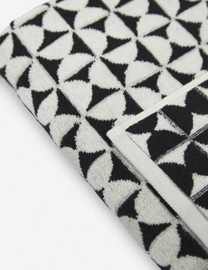 Close-up of the Harper black and white towel by house number 23 with white half-moon designs
