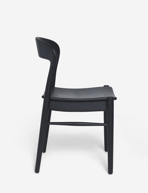 Side view of the Ida black teak wood dining chair.