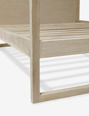 Close-up of the bottom-frame and the support wood paneling on the Kiery light wood canopy bed