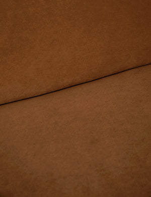 Where the back and seat of the Lena Cognac Velvet armless sofa meet
