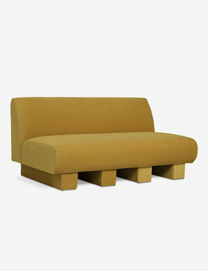 Angled view of the Lena Goldenrod Velvet armless sofa
