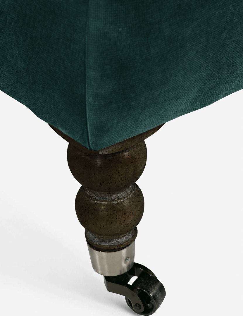 #color::green-modern-velvet #configuration::left-facing #configuration::right-facing #leg-finish::chocolate-and-pewter | The ornate curved legs with wheels on the fabienne green velvet sectional