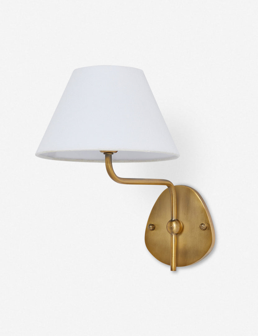 #color::white #finish::brass | Magdalene brass single sconce with a white linen shade, a round wall mount, and an arched arm