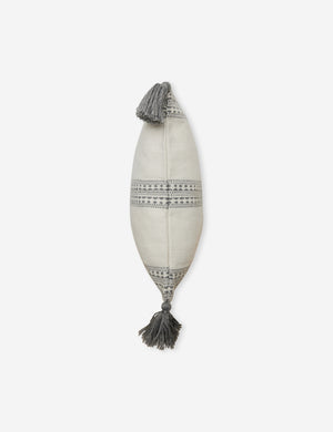 Side view of the Marchesa natural and agate gray indoor and outdoor pillow with tasseled corners