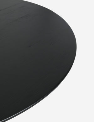 The top of the Maroko black round dining table