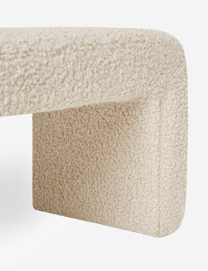 Close-up of the side and inner wall of the Mikhail cream boucle foam-padded bench.