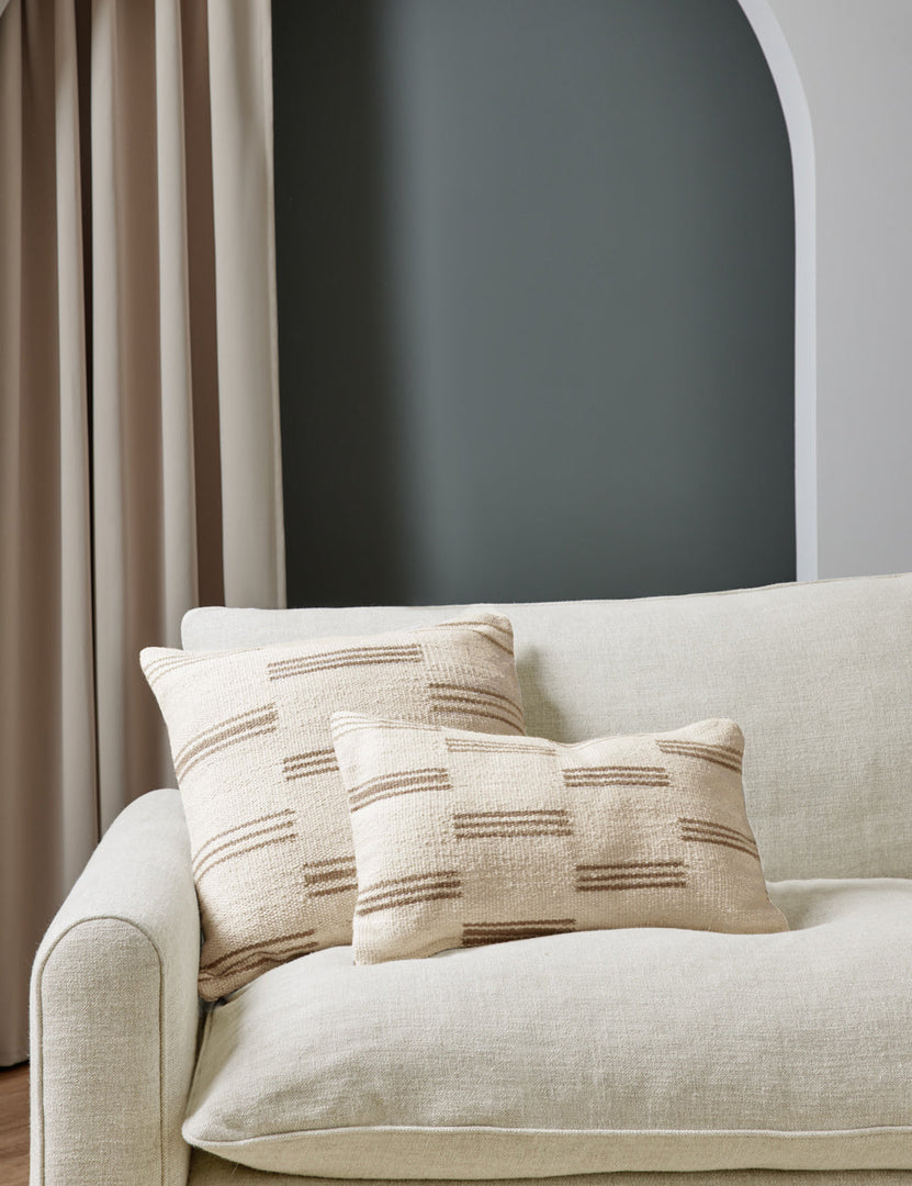 #style::lumbar #style::square | Two Stripe break natural and cream pillows by Sarah Sherman Samuel sit together atop a natural linen sofa in a room with green painted walls