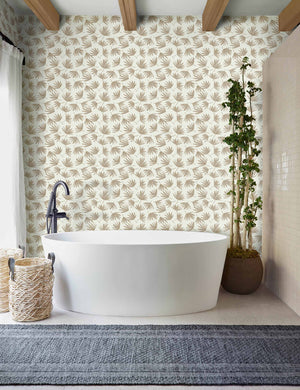 The palms wallpaper is in a bathroom with a white bathtub, a navy runner rug, and wooden beamed ceilings