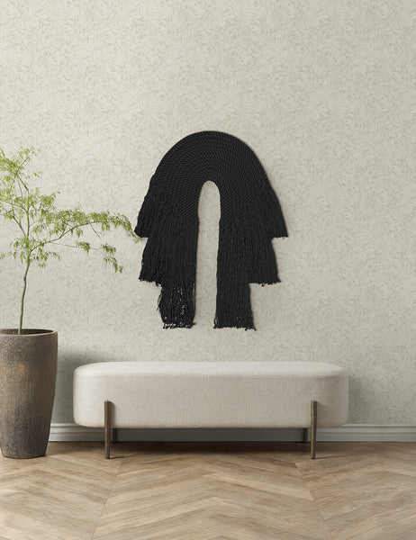 #color::black | The black forte wall hanging hangs on an ivory wall above a white linen bench