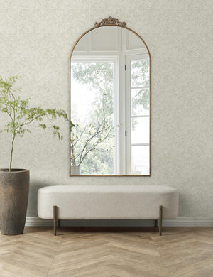 The parma wallpaper is in a room with chevron floors, a large wall mirror, and a stone planter