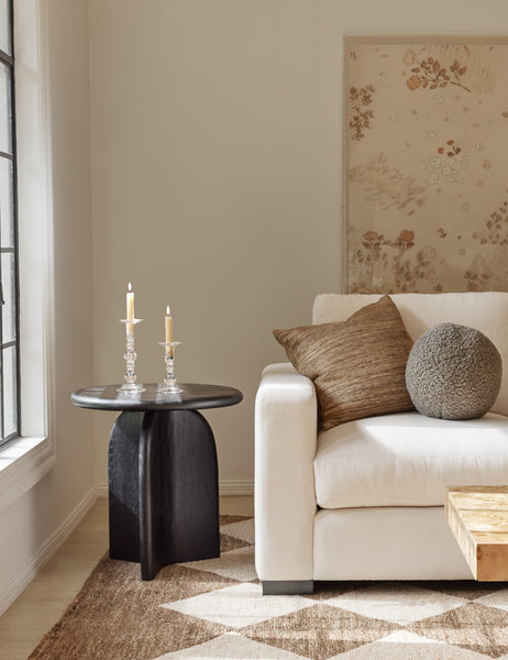 #color::khaki | Khaki gray Bouclé Ball Pillow by Sarah Sherman Samuel sits on an ivory couch next to a black side table and atop a patterned rug