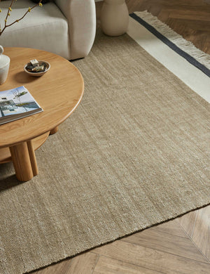 Close up of the Rory rug under an ivory sofa and a round coffee table