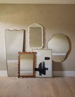The anastasia mirror hangs on the wall of a studio room with other Sarah Sherman Samuel mirrors