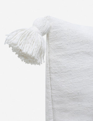 Close-up of the pom pom on the corner of the Sami white lumbar pillow