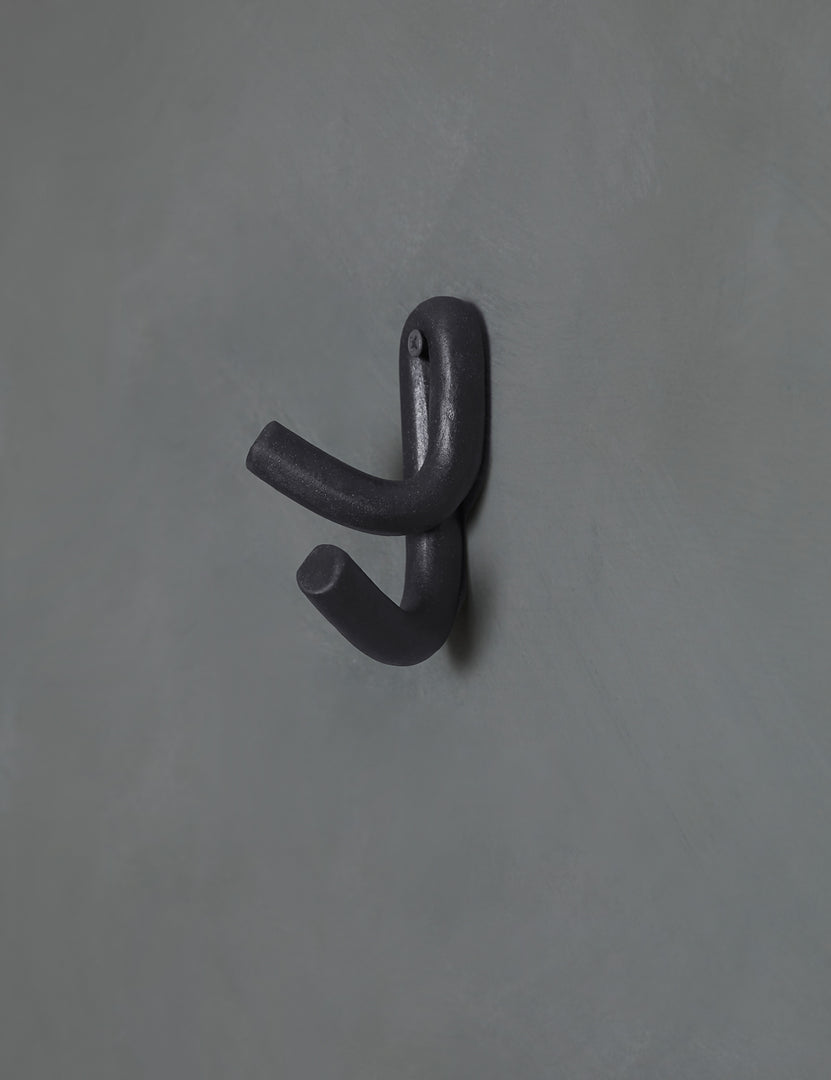 #color::black | Black Leggy Crossed Wall Hook by SIN Ceramics hanging on a gray wall