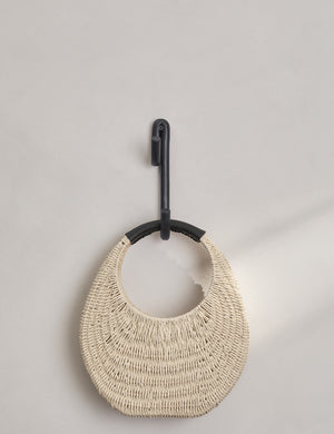 Black Leggy Long Wall Hook by SIN Ceramics with a rattan bag hanging on it