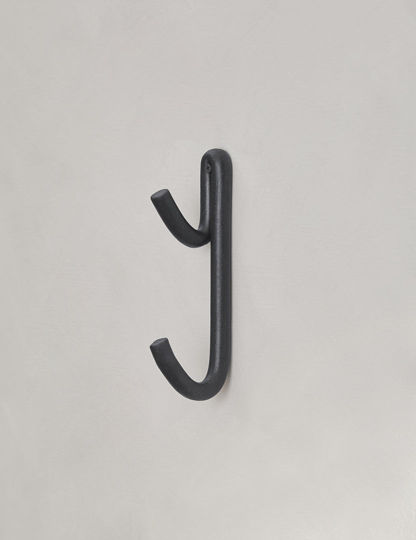 #color::black | Black Leggy Long Wall Hook by SIN Ceramics hanging from a gray wall