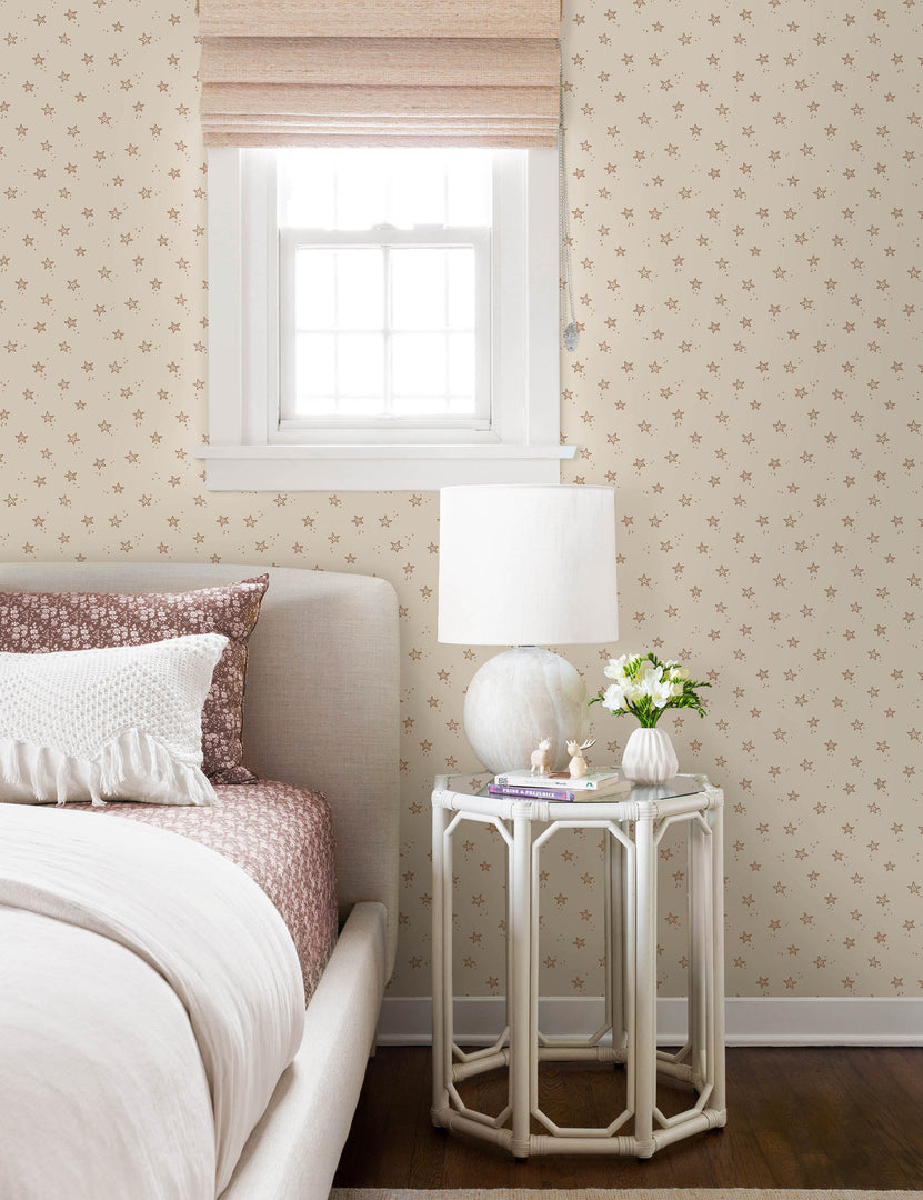 | The starfish wallpaper is in a bedroom with natural framed bed next to a hexagonal white nightstand