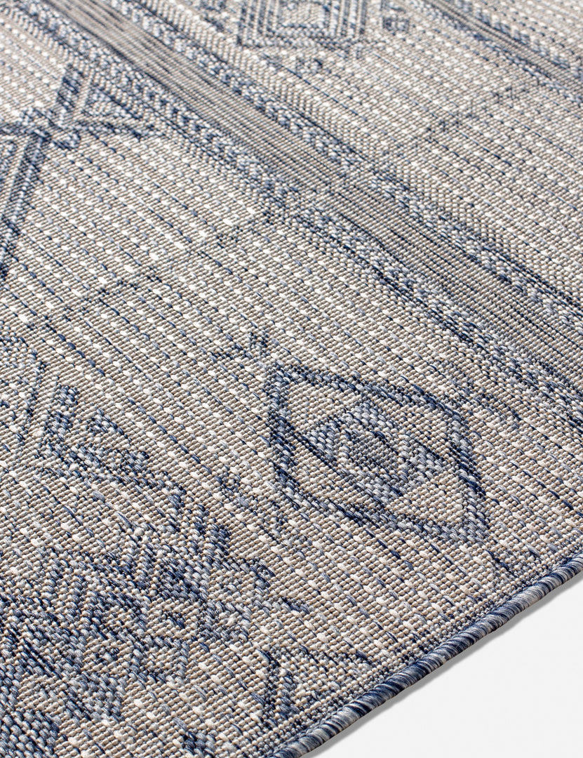 #color::blue #size::5-3--x-7- #size::6-7--x-9- #size::7-10--x-10- #size::9-2--x-12- | Close-up of the Yamina blue indoor and outdoor rug