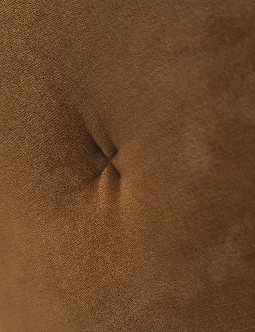 #color::amber | Close up of the "X" stitch in the center of the velvet disc pillow by Sarah Sherman samuel