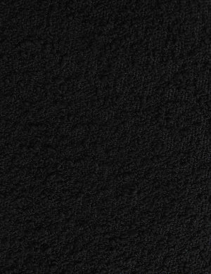 Detailed shot of the black boucle fabric on the Whit black wood sculptural dining chair by sarah sherman samuel