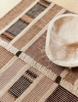 Close up of the Anni Rug sitting under a wooden centerpiece bowl