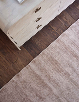 Bird's-eye view of the dusk dylan rug next to a white washed dresser