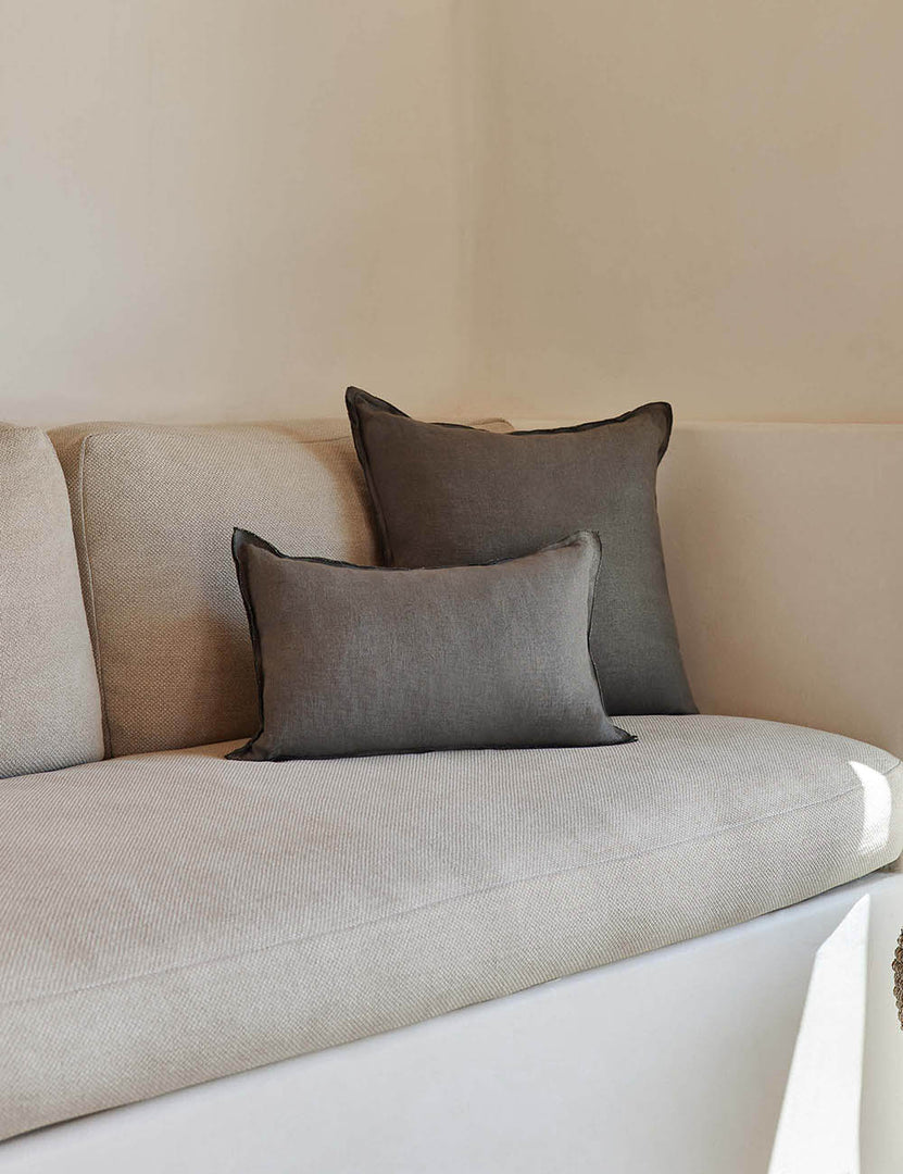 #color::conifer #style::lumbar #fill type::with-feather-down-insert #fill type::pillow-cover-only | The arlo Conifer gray flax linen pillow in its lumber and square sizes sit together on a natural linen sofa